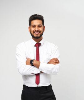 Portrait of young indian top manager in t-shirt and tie crossed arms and smiling on white isolated background